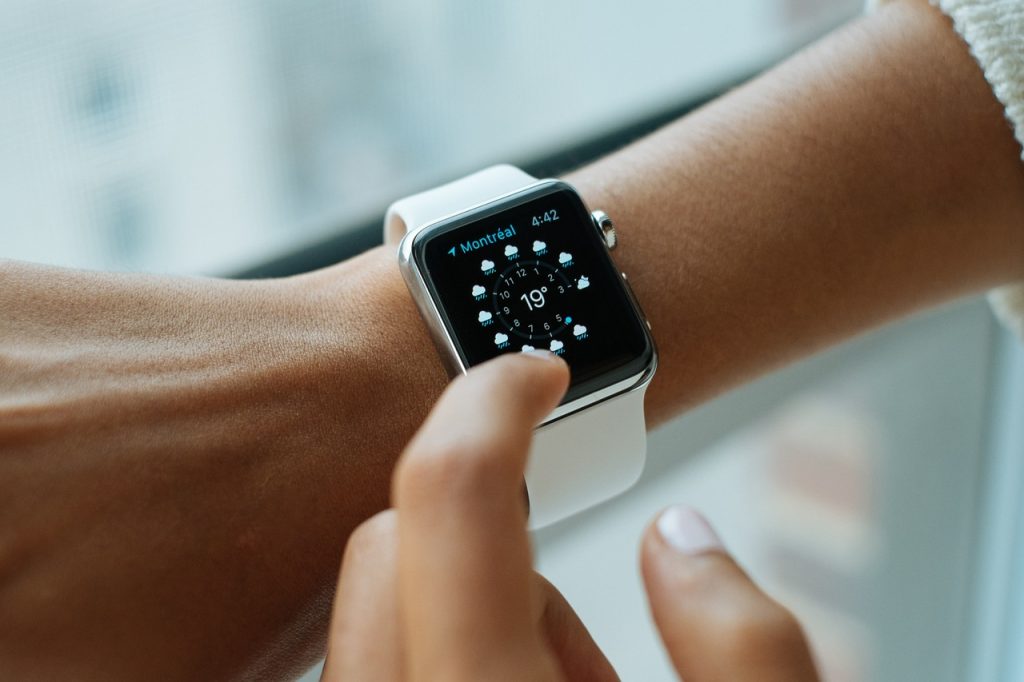 La mano di una donna indica un Apple Watch, evidenziando l'intersezione tra tecnologia e crononutrizione.