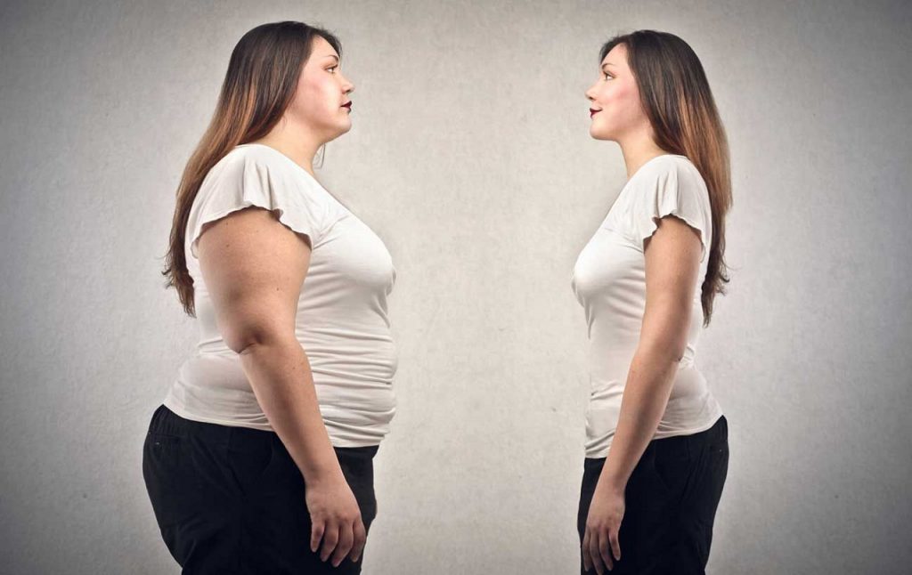 Una donna che si guarda prima e dopo la perdita di peso.